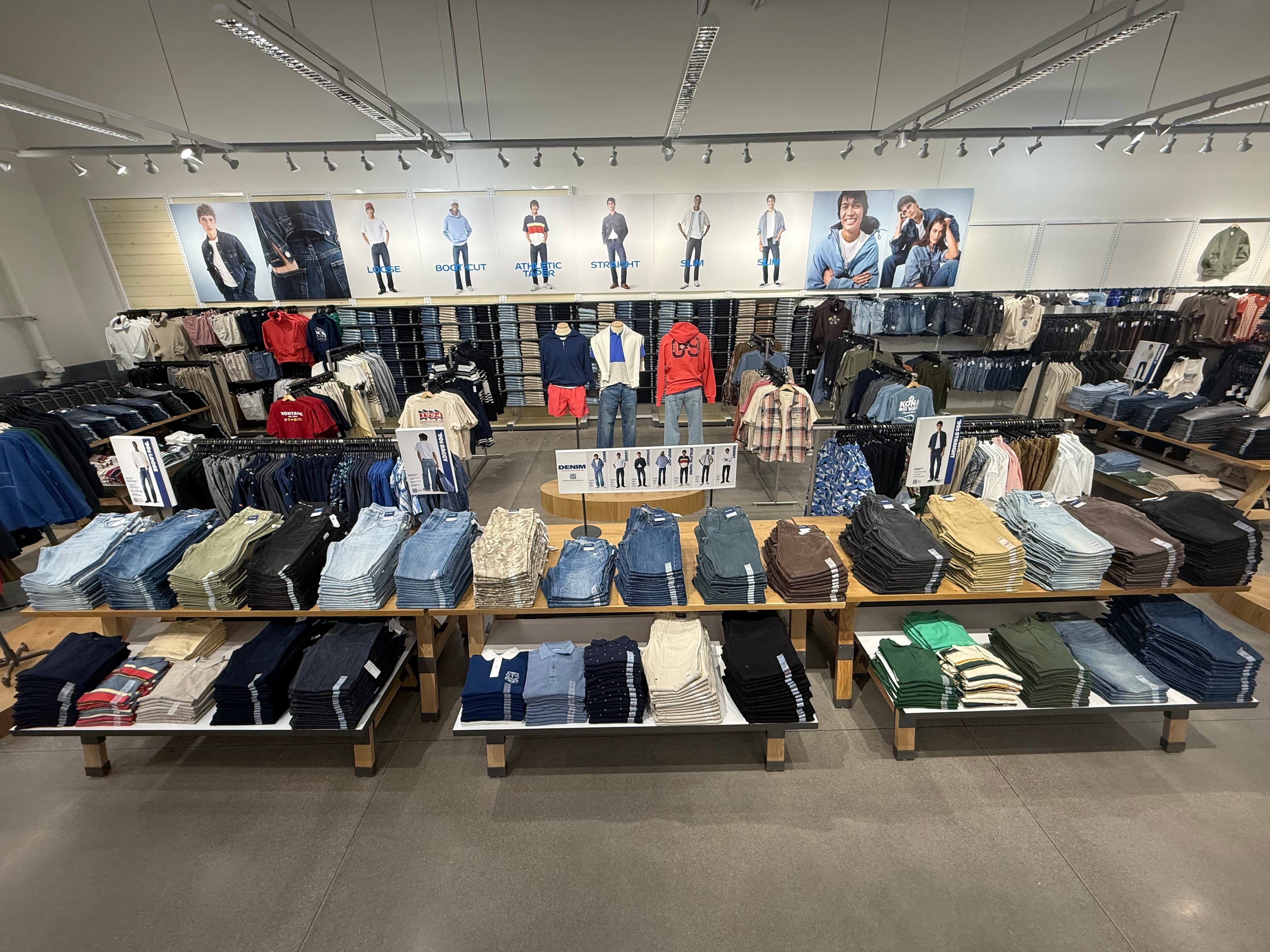 Men's denim department — aerial view with folded tables and mannequins