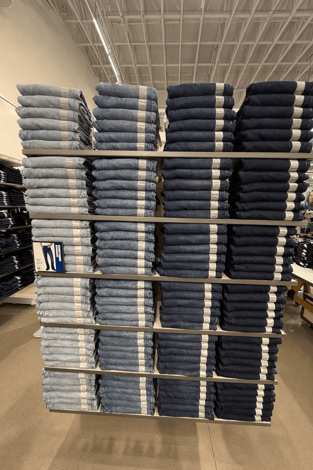 Denim wall — light and dark wash jeans folded by color and size